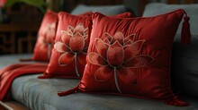 a group of red pillows with a flower design on them