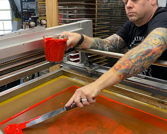 a man painting a screen