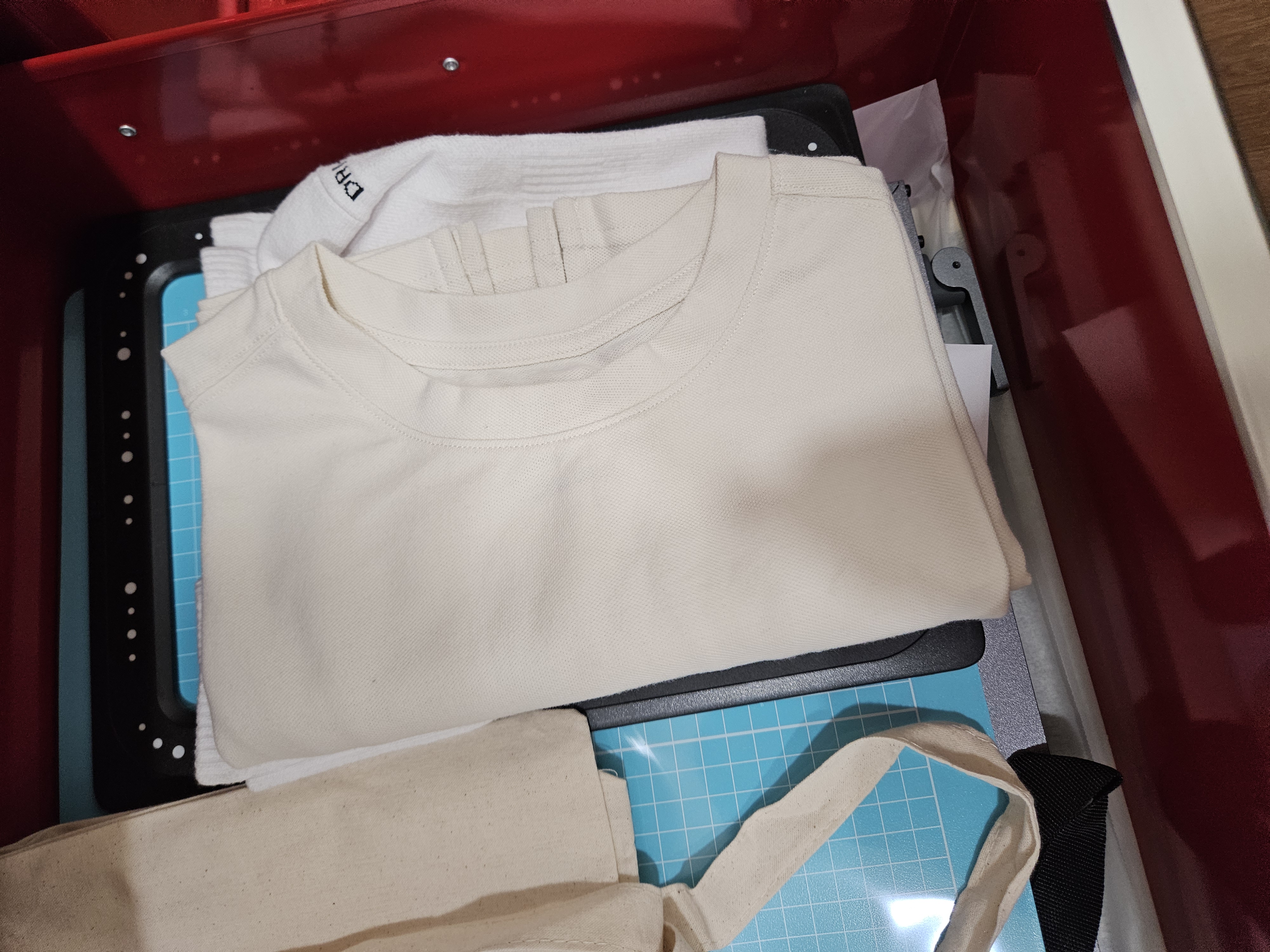 a white shirt and a bag on a blue tray
