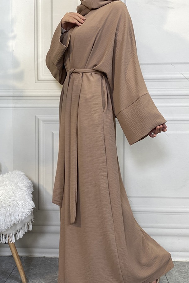 a woman wearing a brown robe