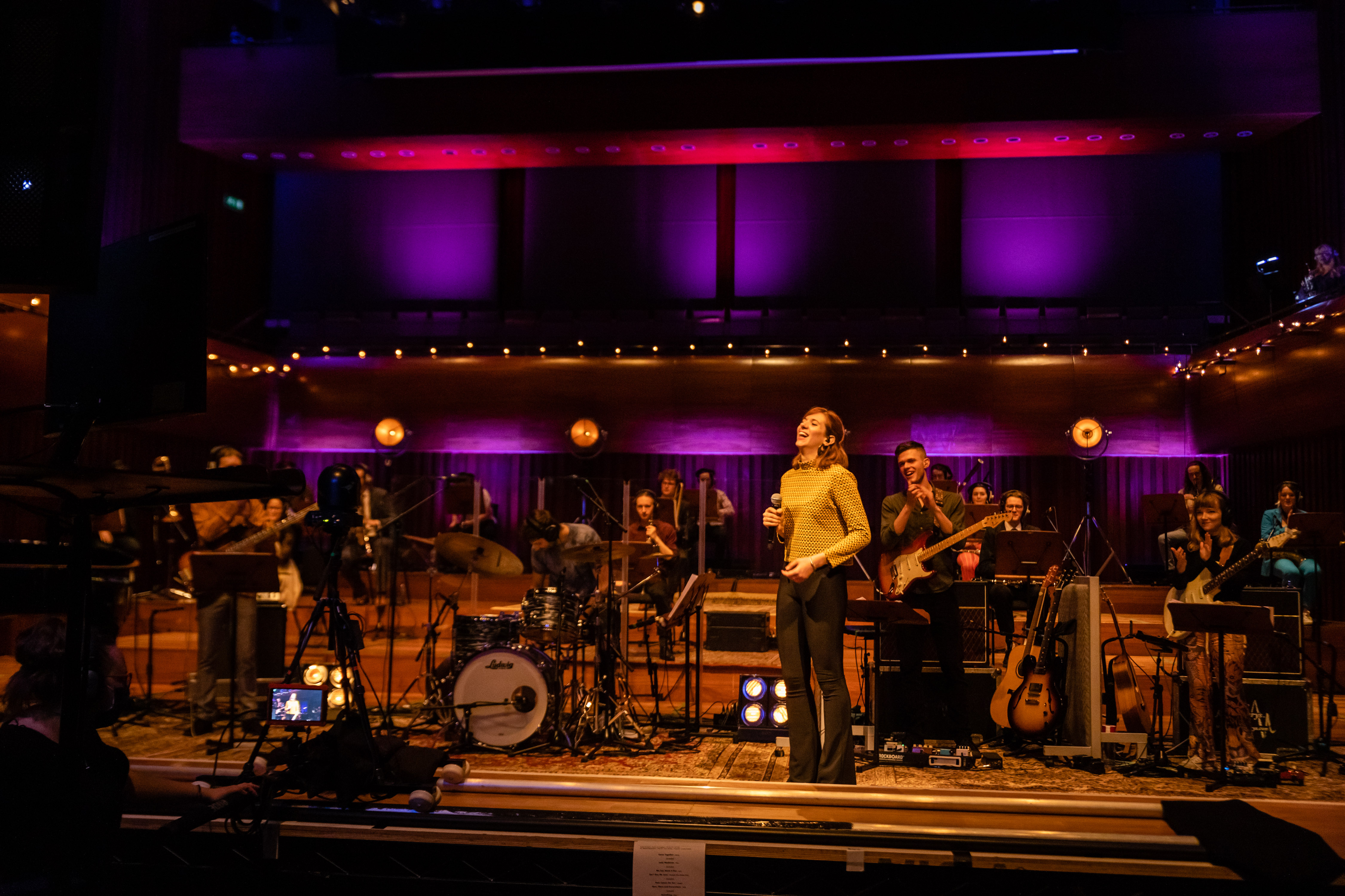 a group of people on a stage with instruments and a microphone