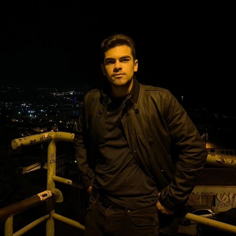 a man standing on a railing at night