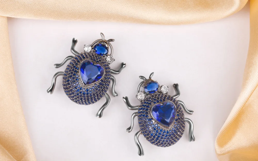 a pair of bugs with blue gems