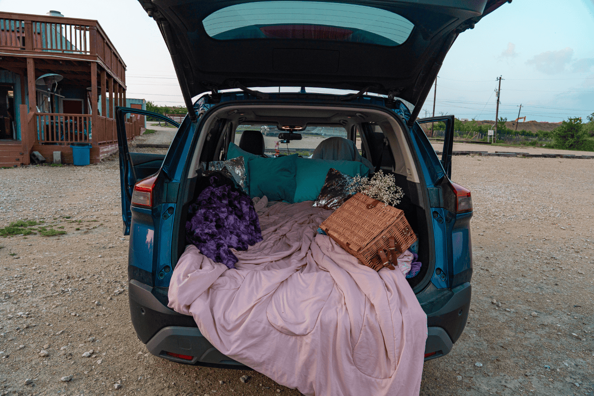 a car with a blanket and blankets in the back