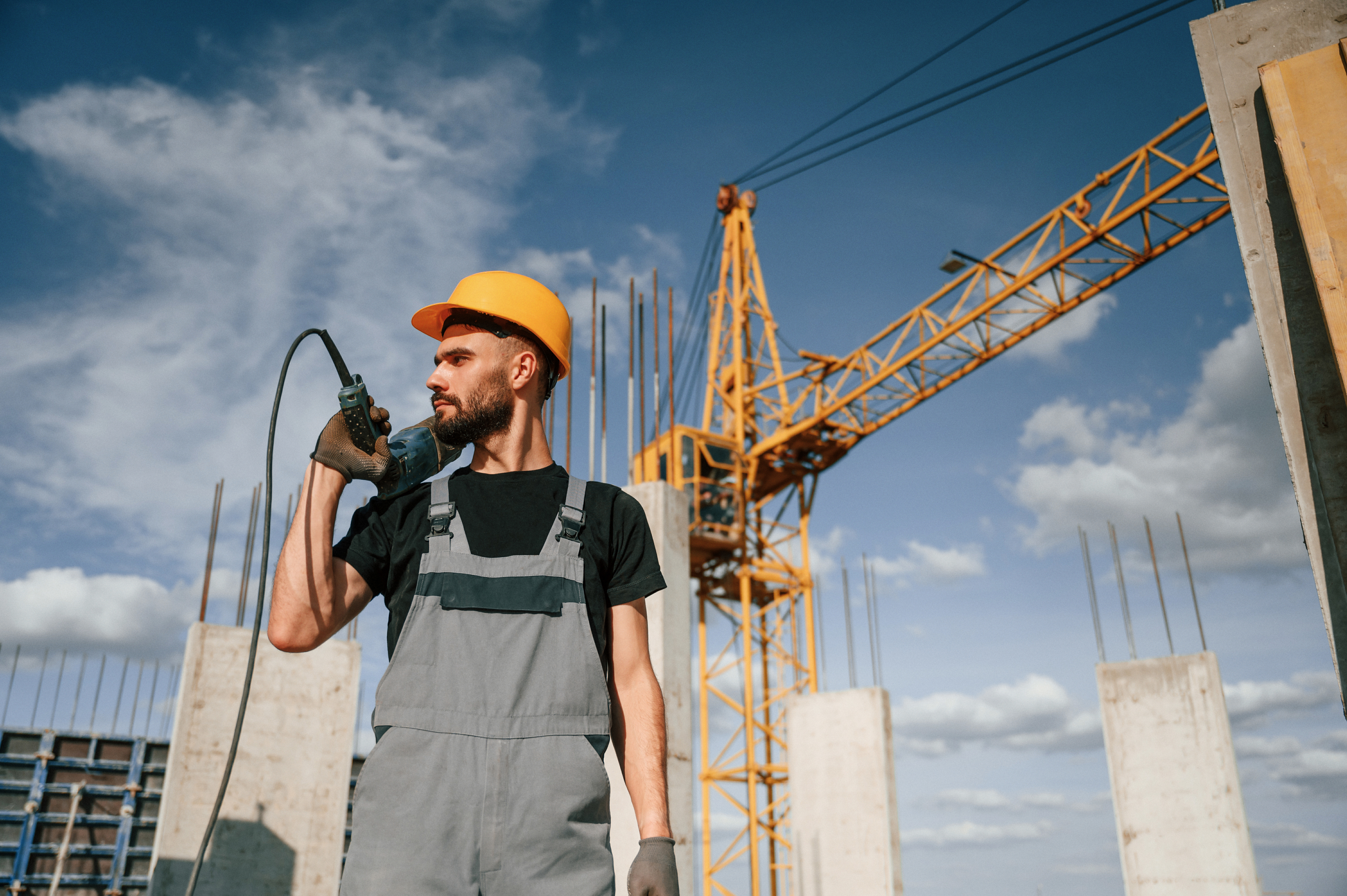 a man in a hard hat holding a drill