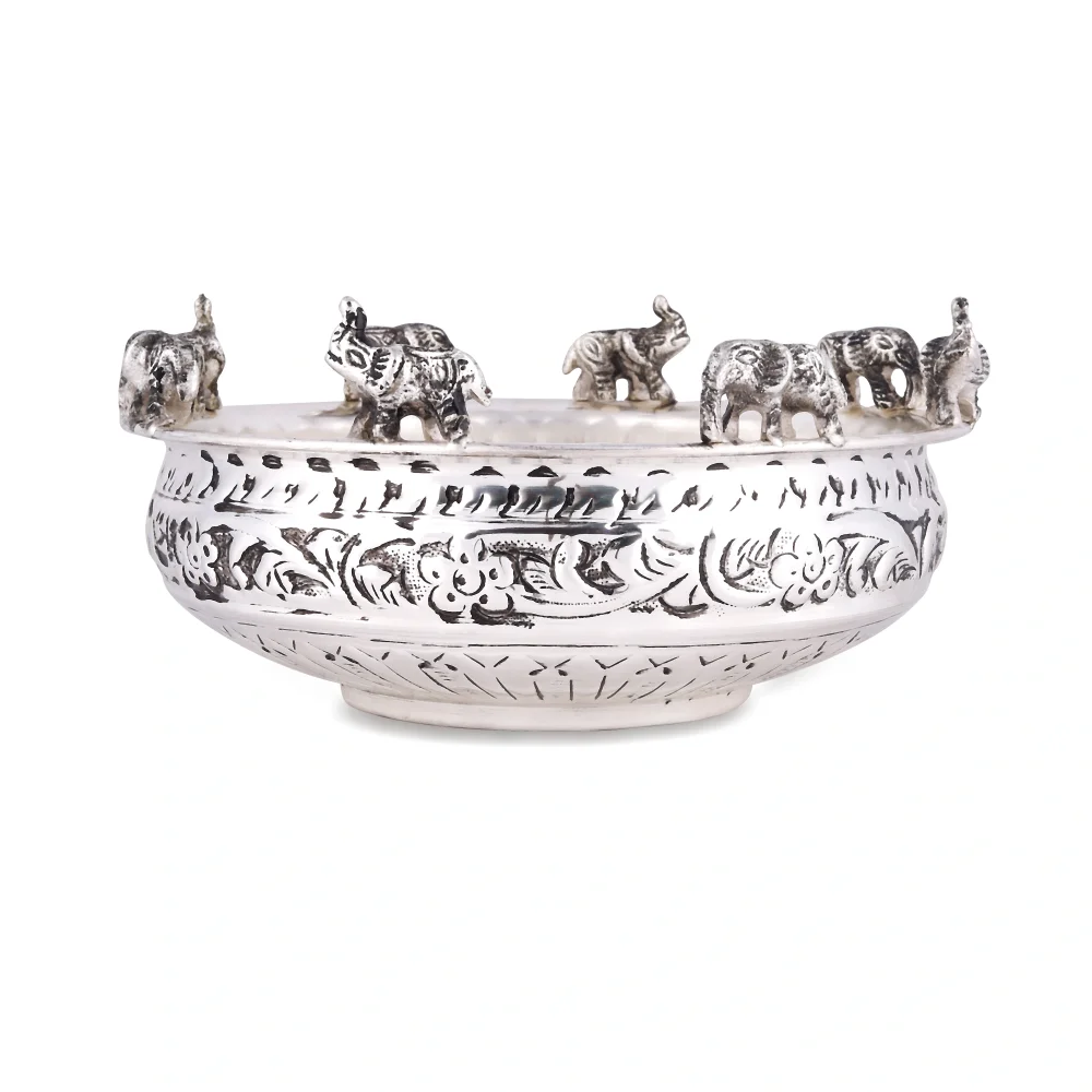 a silver bowl with elephants on it