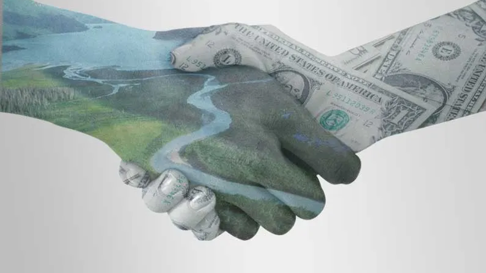 hands shaking hands with money