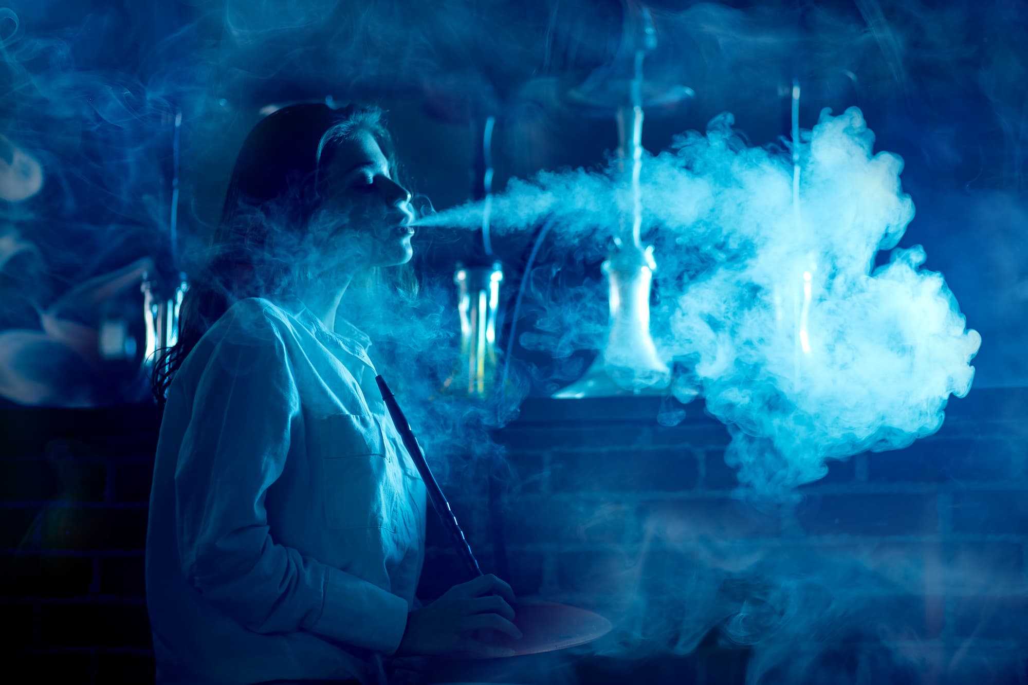 a woman smoking a hookah