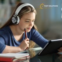 a girl wearing headphones and looking at a tablet