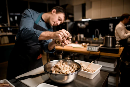 a man in a kitchen preparing food