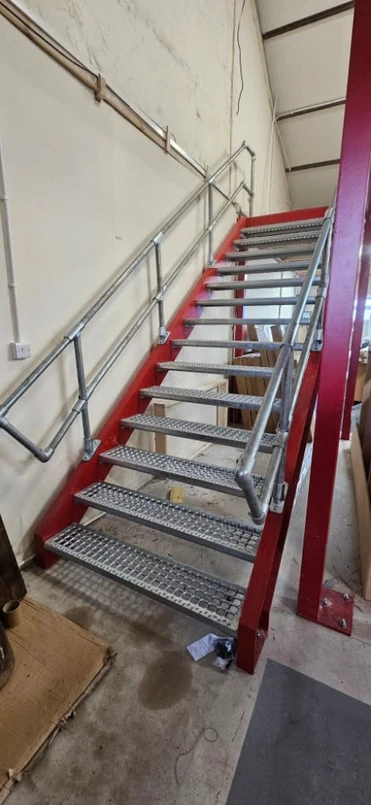 a metal stairs with metal railings