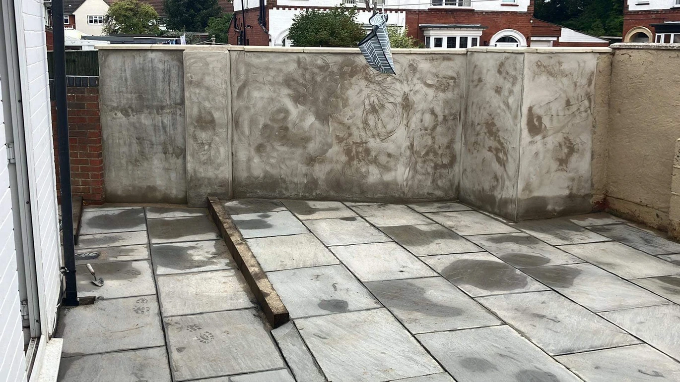 a concrete patio with a metal object on it