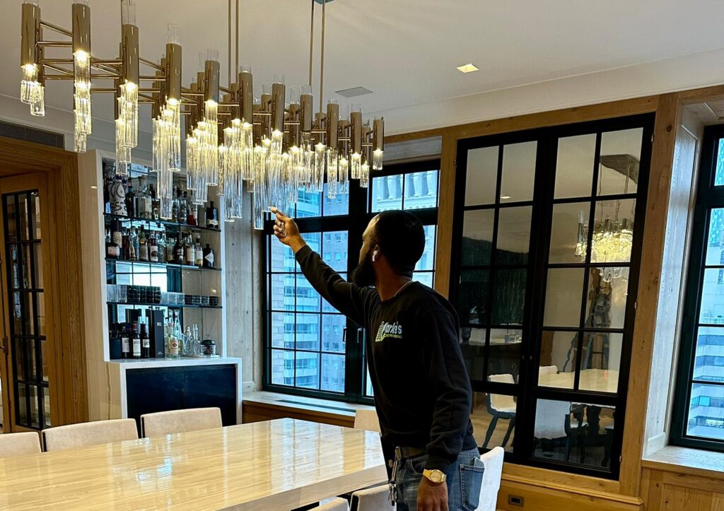 a man standing in front of a chandelier