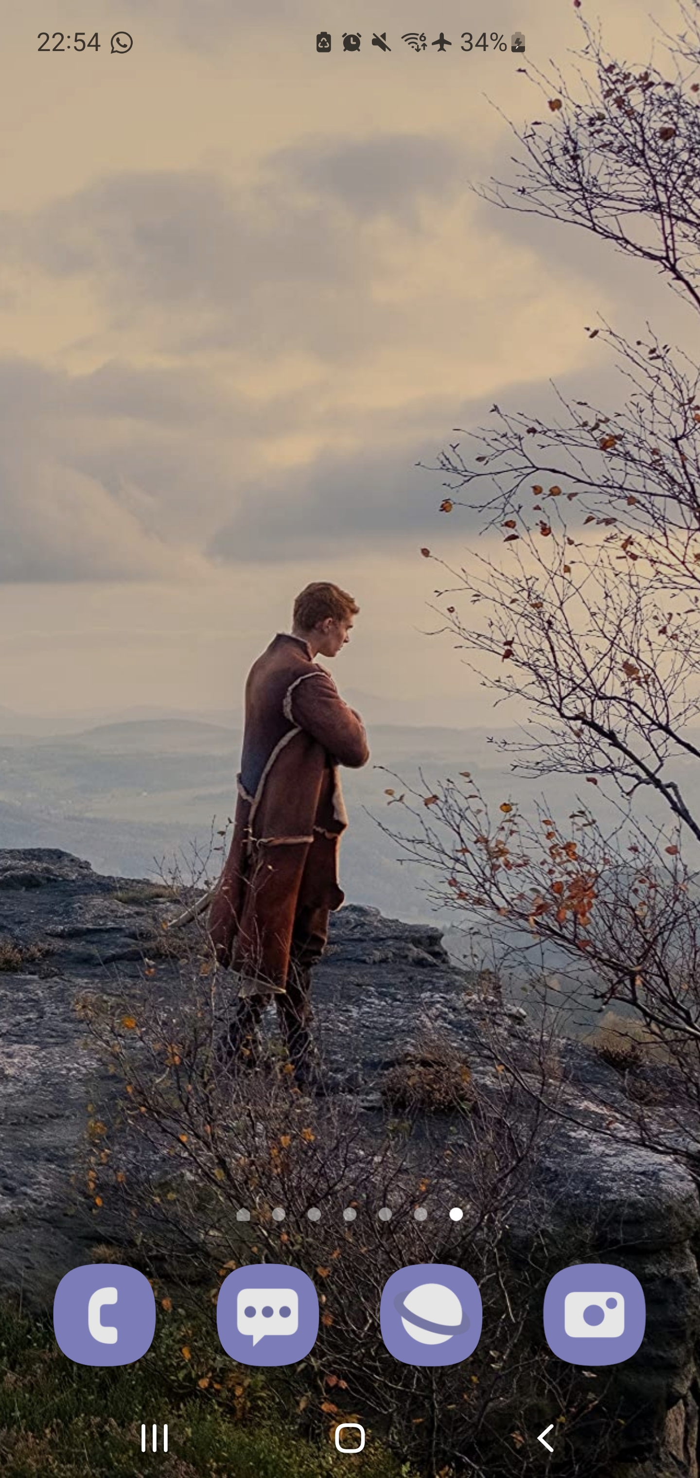 a man standing on a rock looking at a valley