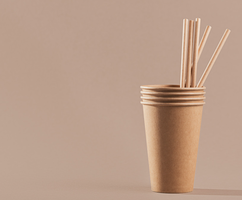 a stack of paper cups with straws