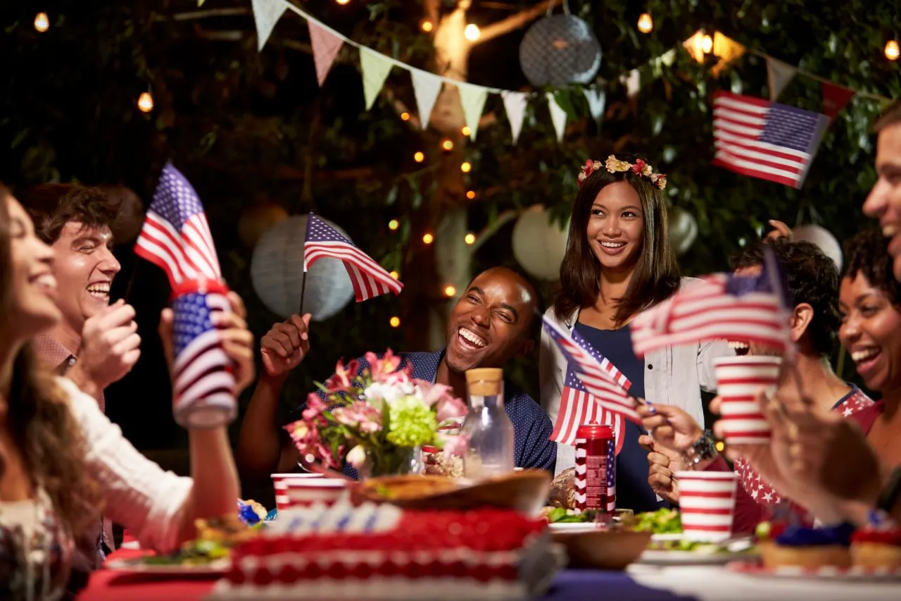 a group of people sitting at a table with flags