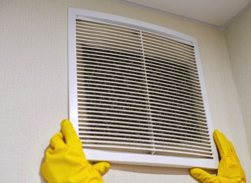 a person wearing gloves holding a vent