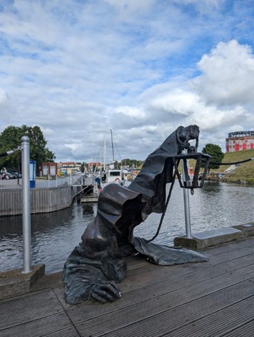 a statue of a person holding a lantern