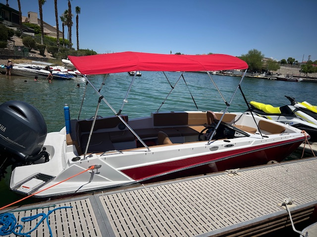 a boat with a red canopy on the water