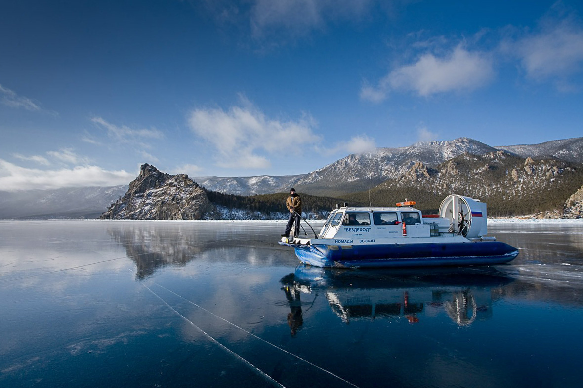 a person standing on a boat on a frozen lake