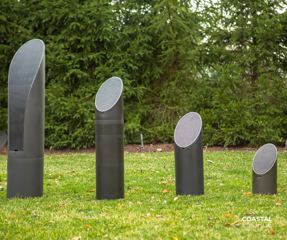 a group of black objects in a grassy area