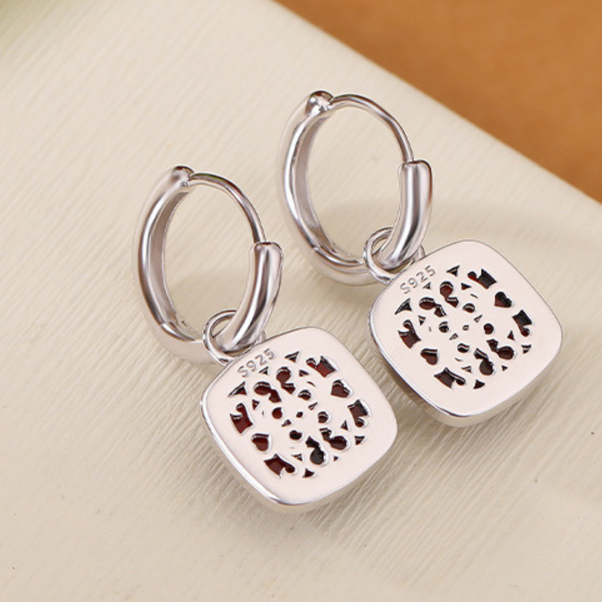 a pair of silver earrings