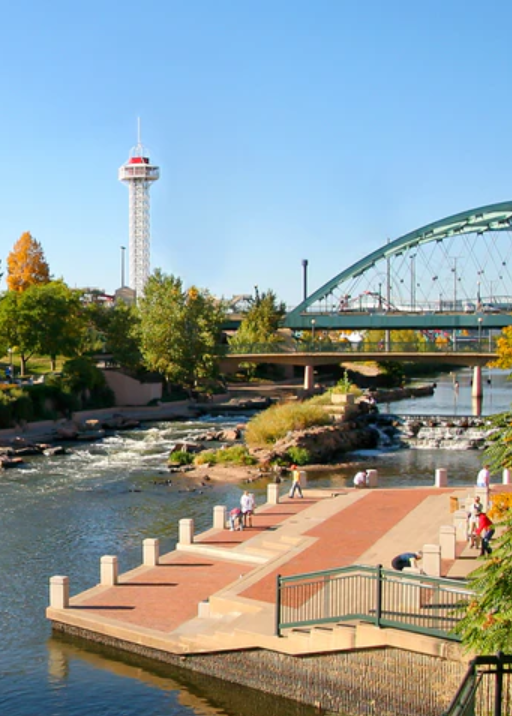 a river with a bridge and a tower