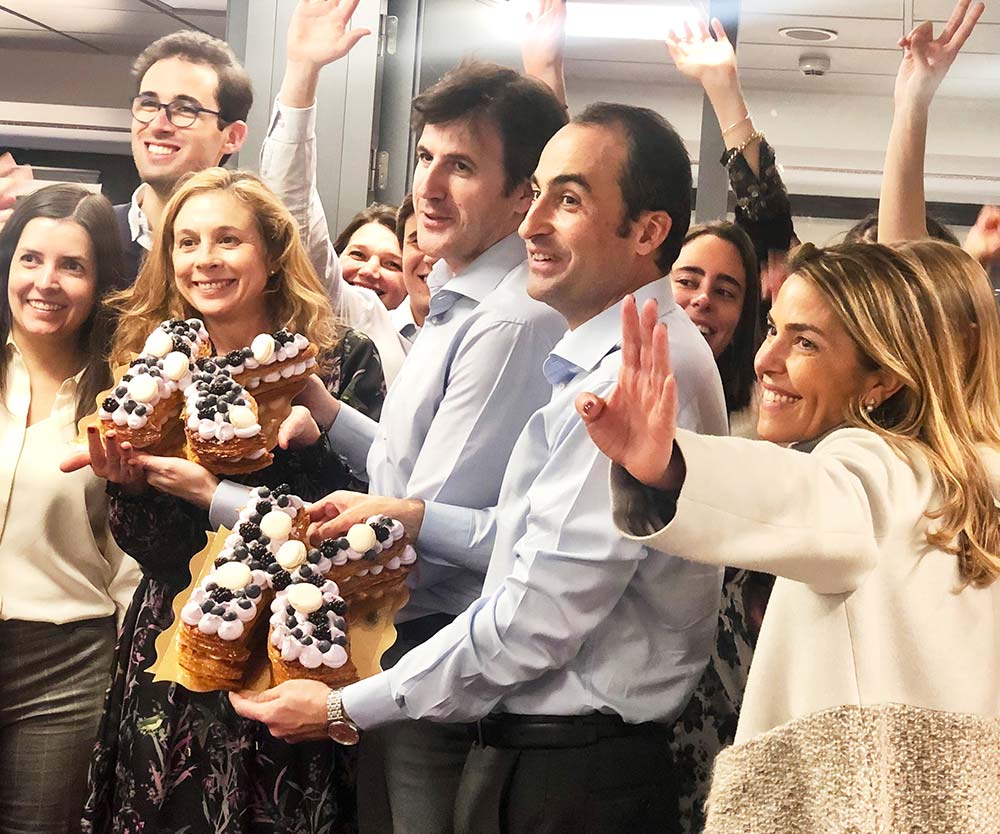 a group of people holding cakes