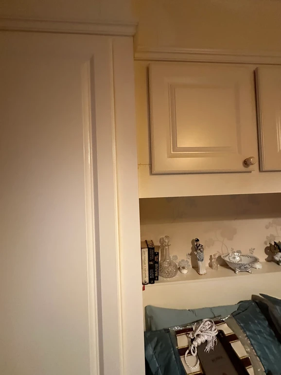 a white door with a shelf and objects on it