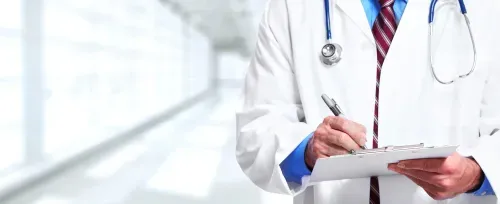 a close-up of a doctor writing on a clipboard