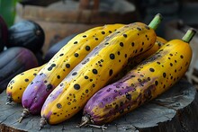 a group of yellow and purple squashes