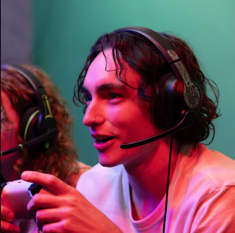 a man wearing headphones and holding a game controller