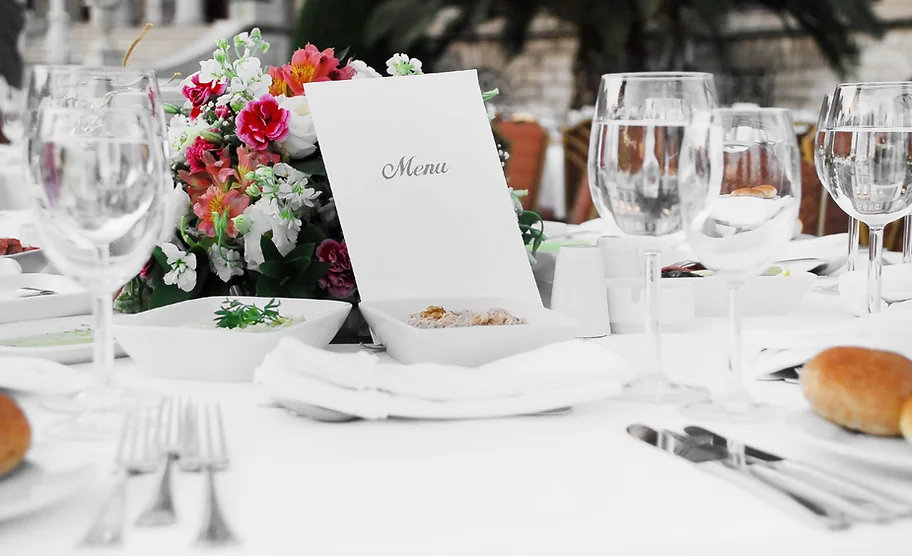 a table with a menu and flowers