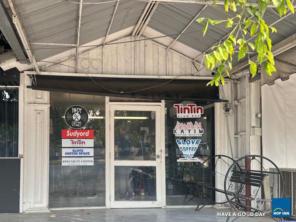 a store front with glass doors and signs