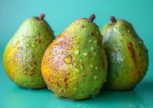 a group of pears on a blue surface