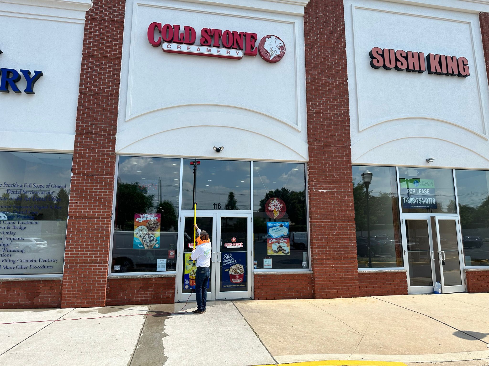 a person cleaning the front of a building