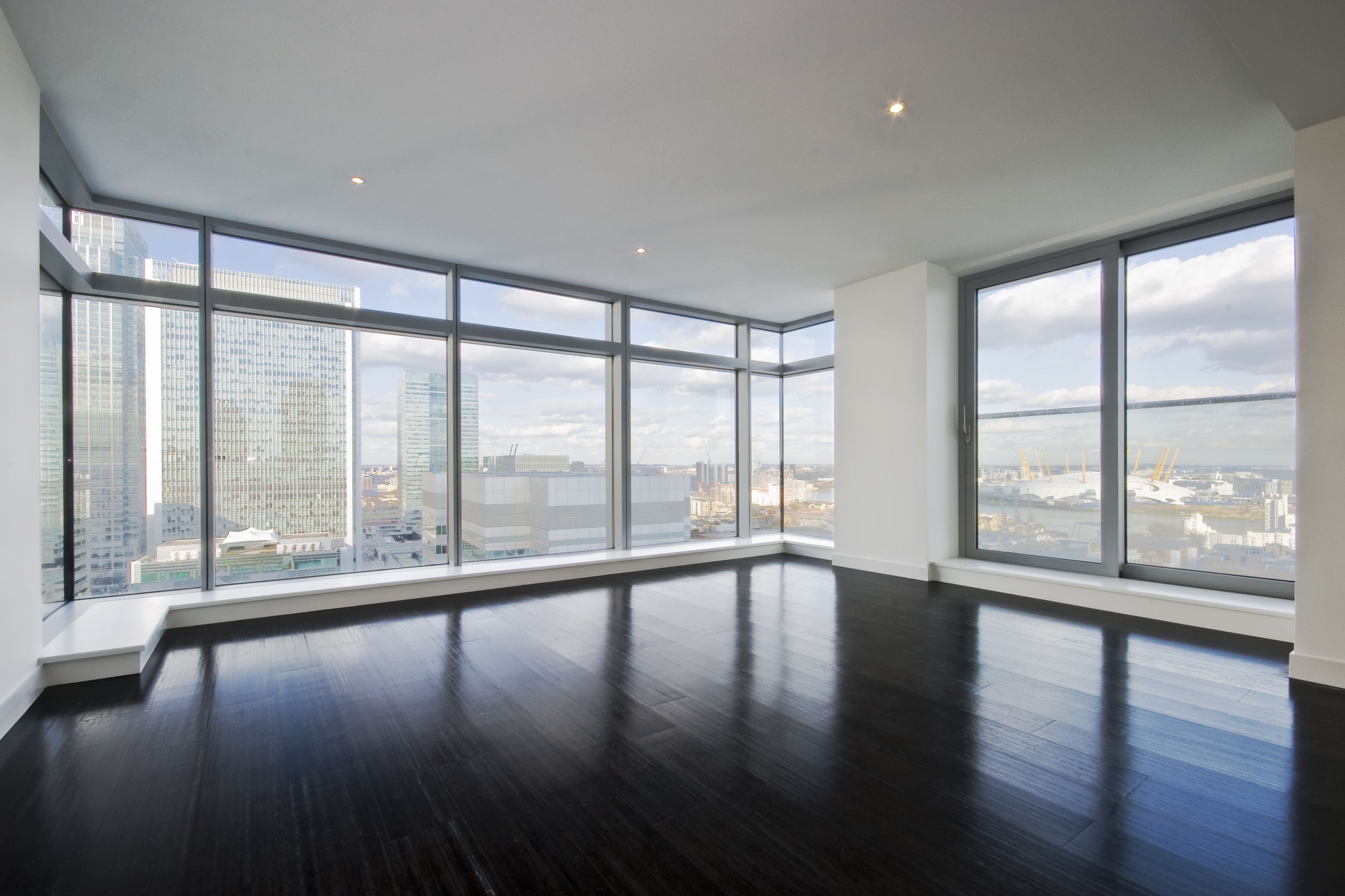 a large room with large windows and a view of a city