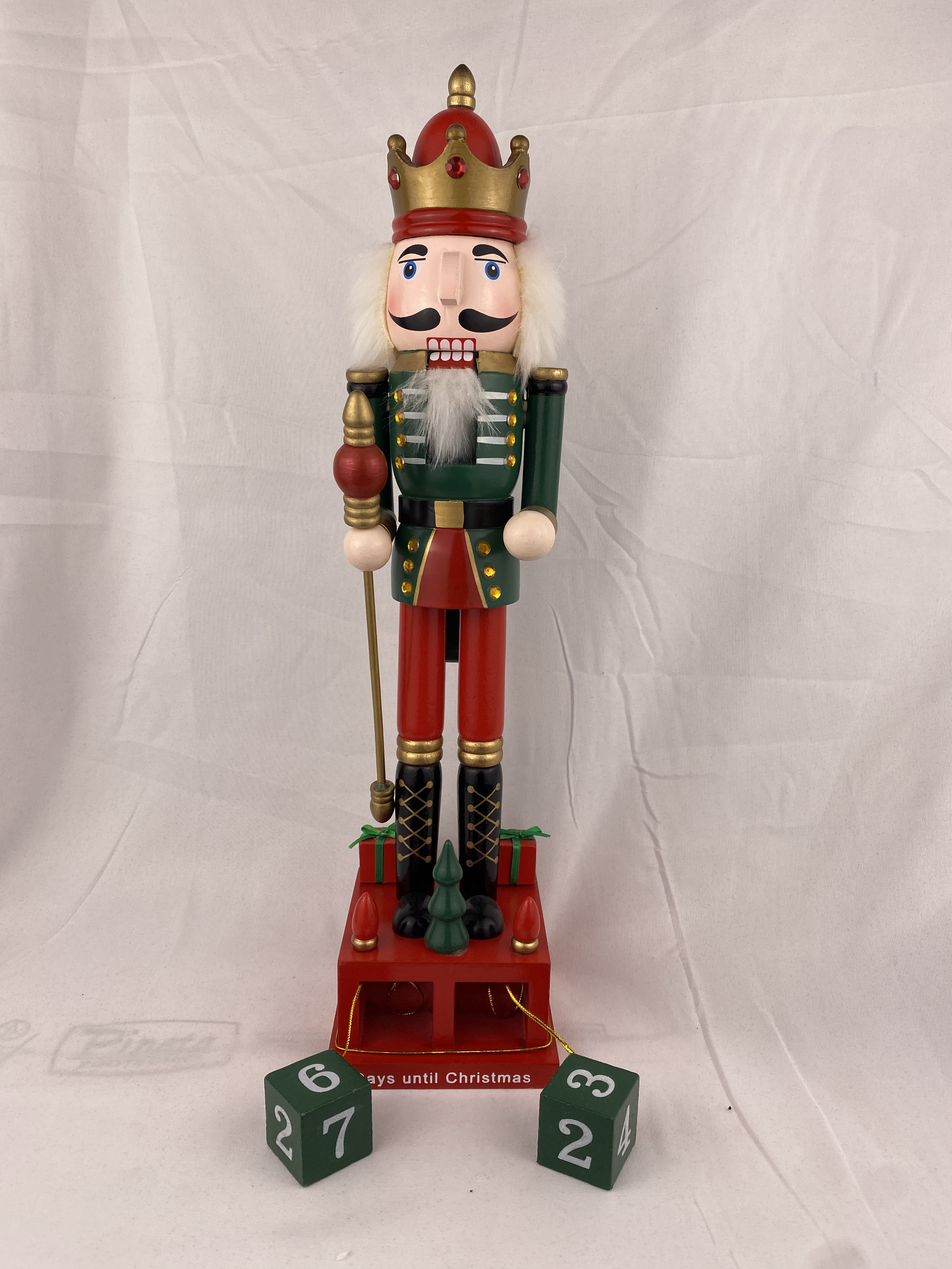 a nutcracker with a crown and a cane