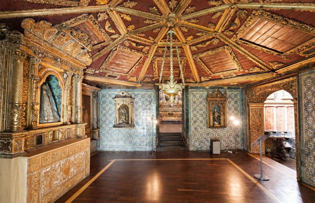 a room with ornate walls and a wood floor