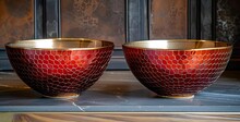 a pair of red and gold bowls