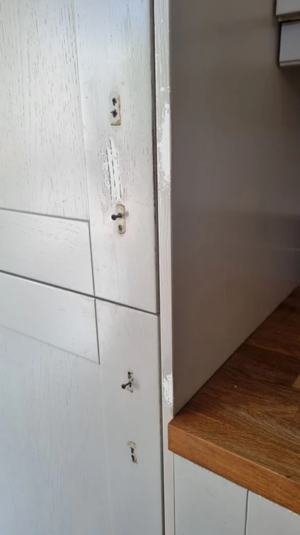 a white cabinet with a door