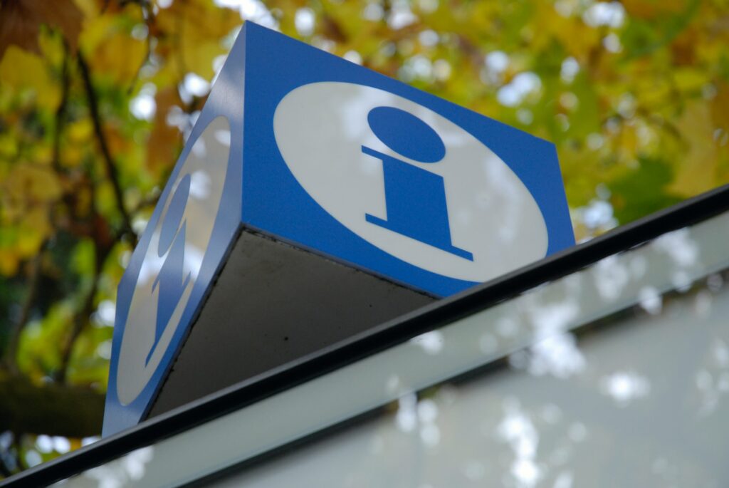 a blue and white sign on top of a building