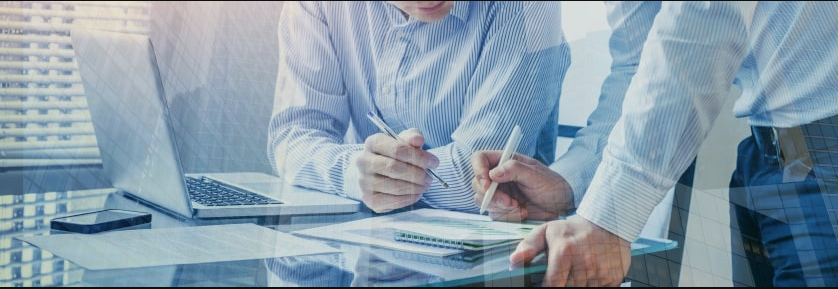 a group of people holding pens and writing on a notebook