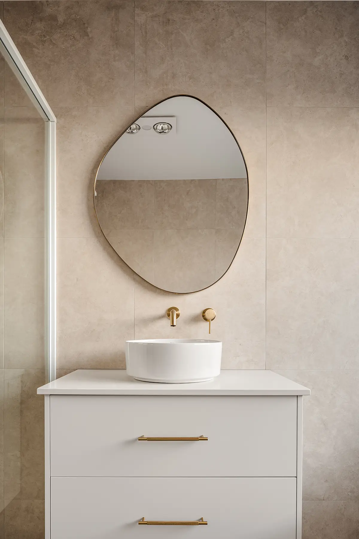 a sink and mirror above a counter