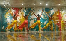 a group of women dancing in front of a wall with colorful leaves