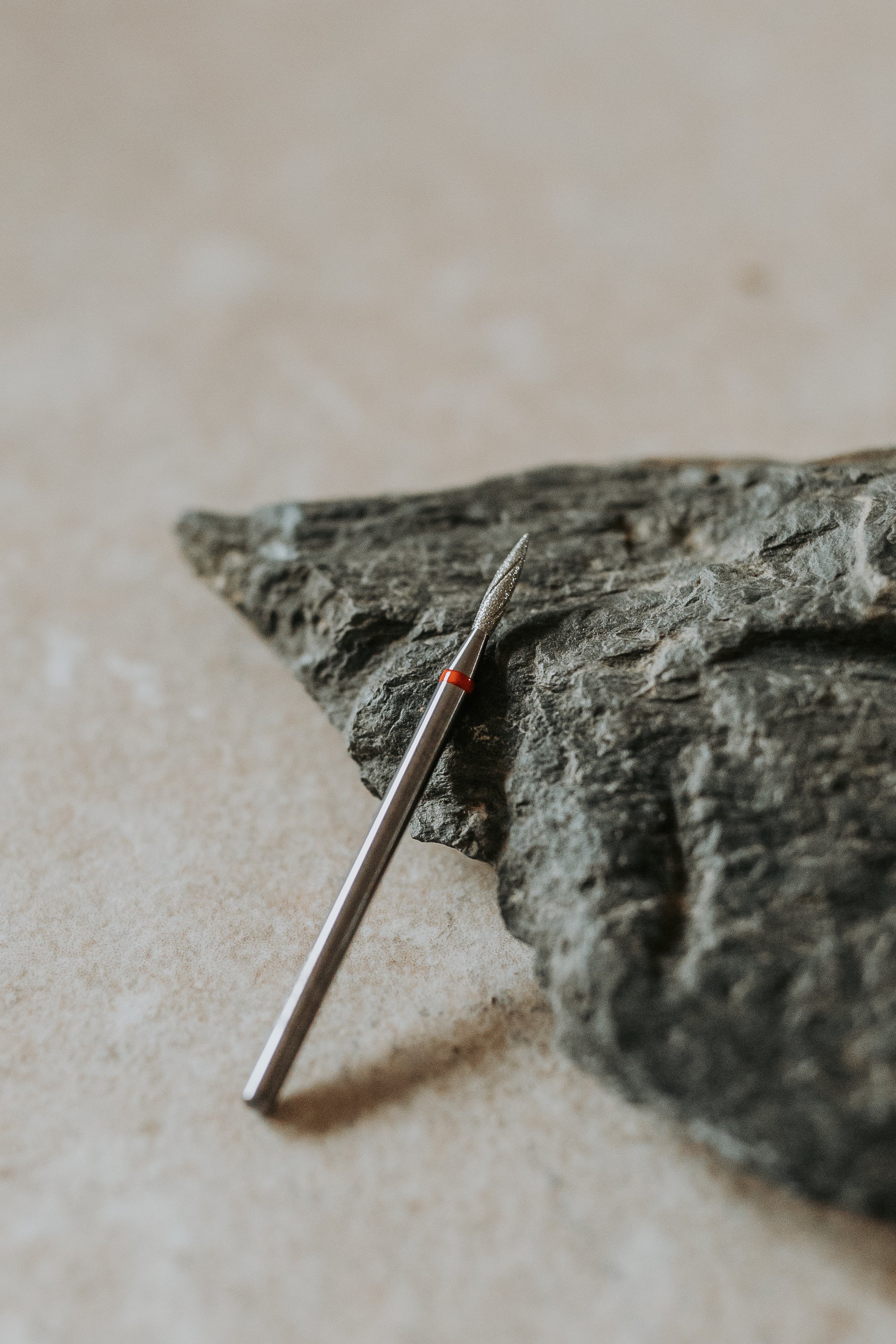 a small metal object on a rock