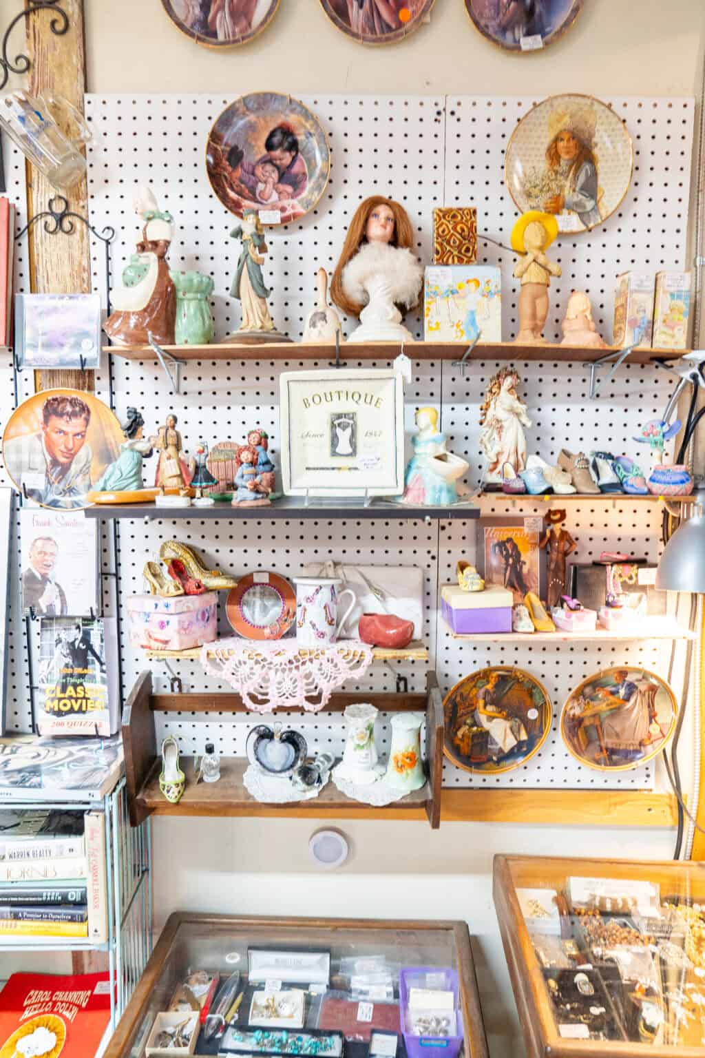 a shelf with figurines and other objects on it