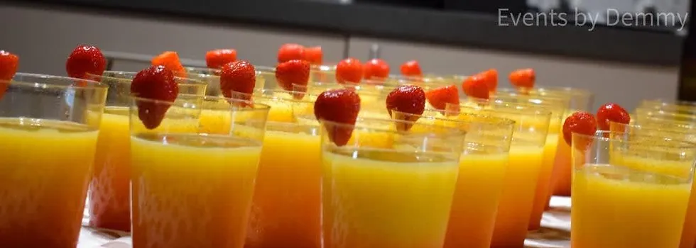 a group of glasses with fruit on top