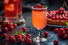 a glass of orange drink with berries on top