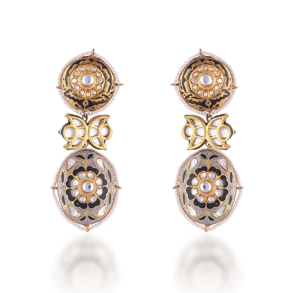 a pair of earrings with gold and silver stones